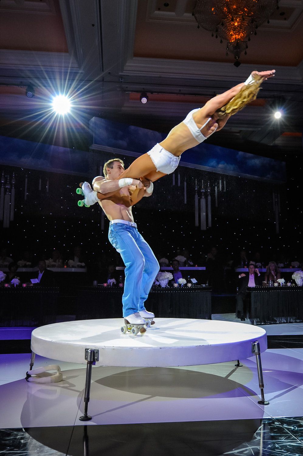 Acrobat balanced on a stage riser