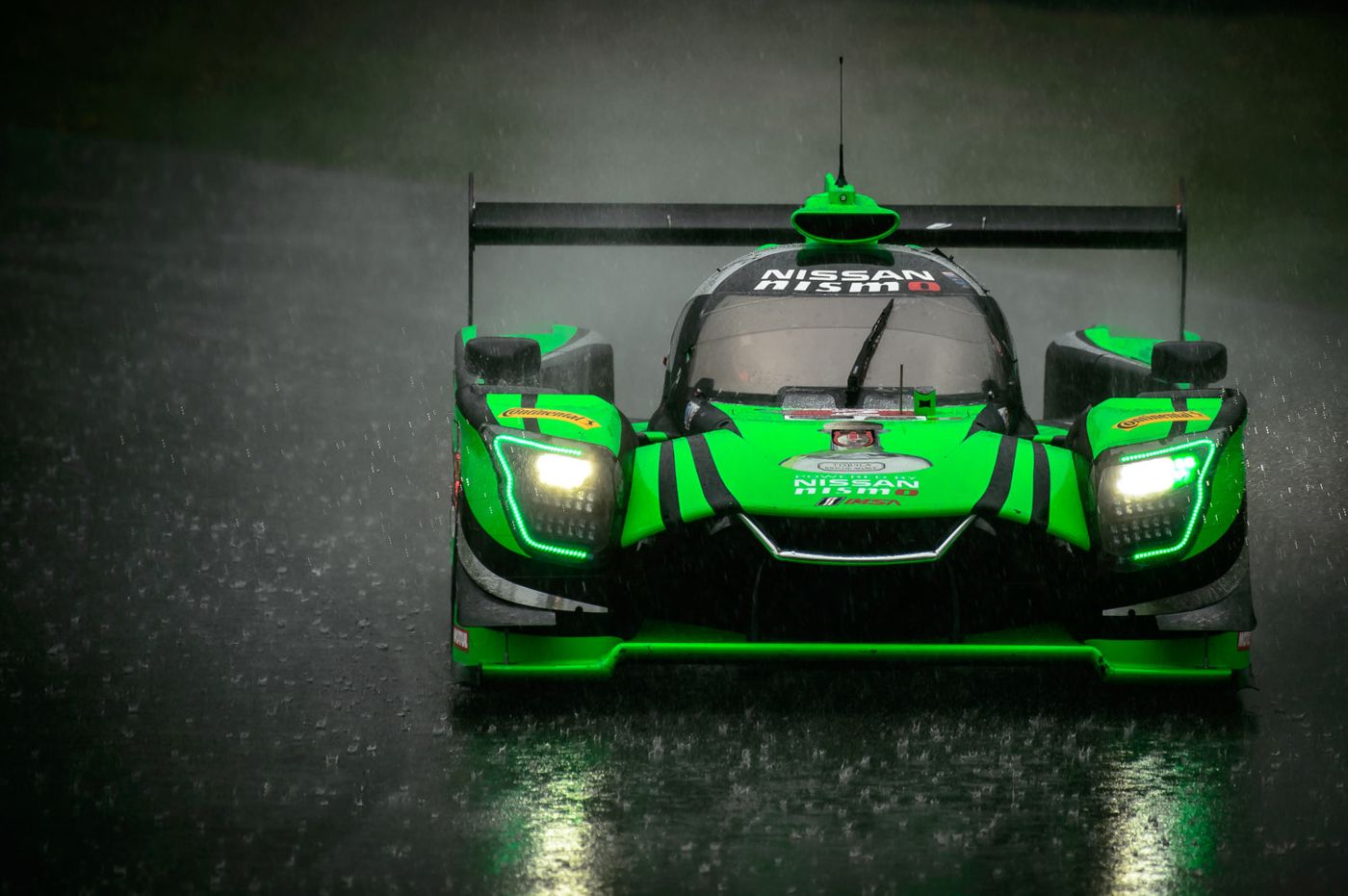 Green prototype race car in the rain