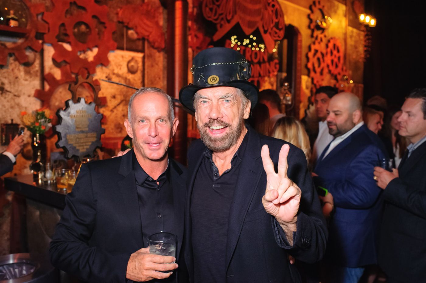 Hosts greeting guests at a private bar